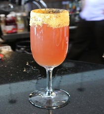 At Rockville’s Quench, head bartender Matt Allred was inspired by the dark essence of All Hallows Eve to create a cocktail that takes trick-or-treat literally. Using a white whiskey named Death’s Door —appropriately morbid — plus lemon, honey, sloe gin, and absinthe, each "Into the Ether" cocktail is ablaze with both fire and flavor. First, the rim of the glass is dipped in homemade candy-corn crumble, so each sip is a sweet treat. As for the trick, when the ignited absinthe meets the remaining chilled ingredients, smoke creeps up the sides of the glass. Creepy, huh?
Where: 9712 Traville Gateway Drive, Rockville; 301-424-8650.
Photographed by Giselle Childs Quench_Into-the-Ether