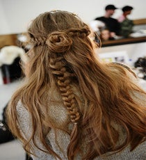 Hairstylist Odile Gilbert worked with John Frieda products (key pick: Curl Reviver mousse) to create "rocker princess texture" at Rodarte, braiding both sides of the hair and connecting them in the back to create a rosette bun. Some models wore barbed wire headbands atop this look — what could be more badass than that?
Photographed by Nina Westervelt/MCV Photo rodarte-photoshop