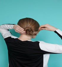 To create the chignon, pull the rope braid up and around itself, securing with bobby pins that match your hair color as you go. bun-6