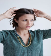 Like all of the hairstyles in our slacker beauty guide, this look works best on second-day, unwashed hair. Start by sectioning off the crown of your hair.
Joie Marlo D Top, Noise Girl Lyle Necklace quick-beauty-1