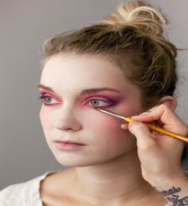 Repeat the prior step using a brighter purple hue, making sure to blend the color above the plum in an upwards and outwards direction. Evans says to be sure to connect the shadow under the lower lash line, pulling it up and out to create a lifted effect. 10_HalloweenLook1_091512_286