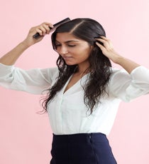 Add some gel to your hair and create a slightly off center-part using a wide-tooth comb. Since this 'do is all about sculpting, Brill recommends using a stronger hold gel. She likes to use a drugstore brand — Krystal Eco Styler Alcohol-Free Styling Gel — because "cheap gel is always the best kind of gel for styles like this, where you want a more defined look. It stays wet-looking and helps hair maintain texture, so you don't show up to work with your hair looking one way, then have in-between frizz by lunchtime." LowBun_012_R