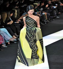 Anne Hathaway usually opts for dresses in very classic, demure shapes. This Armani Privé striped gown presents that traditional shape but spices it up with on-trend stripes. arm_HCss13_150