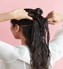 Place your pointer fingers just above your ears and draw them toward the back of your head to create your second section. Repeat the prior steps to create another bun. MultiBun_089_R