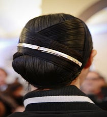 At first glance, this look could be a simple side chignon, but the close-up view shows that it's anything but basic. Working with Kérastase Ciment Thermique to get that super-slick texture, stylist Odile Gilbert created this Art Deco-inspired look, wrapping sections of hair over each other. The two silver barrettes add even more slick, modern texture.
Photographed by Nina Westervelt/MCV Photo jason-wu-photoshop