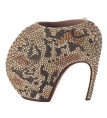 Alexander McQueen's armadillo shoes are most like...Japanese gymnast Asuka Teramoto.
These 10-inch stunners pretty much topped out the competition in terms of jawdroppingly tall heels, but Japan's teeny-tiny gymnast — who is 4 feet, 6 inches tall — can do some serious tumbling, and we're not talking the kind we'd we'd be doing after trying to strut in these bad boys. We'd like to side with shoes so dangerous that the models refused to walk in them, but at the end of the day, they're just not as shiny as the promise of a gold medal. Sigh.Photo: Via The Met alexander