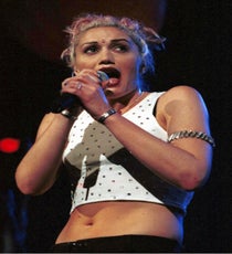 Gwen Stefani & White Muscle Tees
Hey, remember when sleeveless T-shirts were for aerobics classes and plumbers only? Yeah, we can barely recall either. See, since No Doubt crashed through the top of charts with "Don't Speak" 18 years ago (yes, 18 years), it's become perfectly normal for an otherwise luxe-dressed young lady to rock a ribbed tank or other sporty tops along with her statement accessories (questionably appropriate bindis included). Hey, our managing editor has about 20 of them. And, yes, even though she's gone on to much frillier fashions with L.A.M.B., whenever we see a fit female in a white top with her belly and arms exposed, we're always going to think of Gwen Stefani...or aerobics.
Photo: Rex USA
gwen-stefani